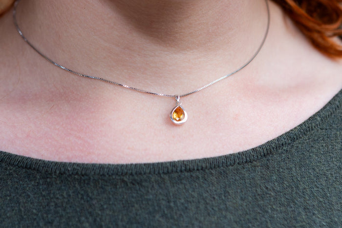 woman wearing gem drop with cremation ash