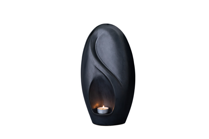 Eternity Ceramic Urn in deep blue with a built in candle holder and sculpted curved motif.