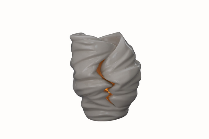White sculptural ceramic candle urn with a twisting form and a warm tealight glowing inside